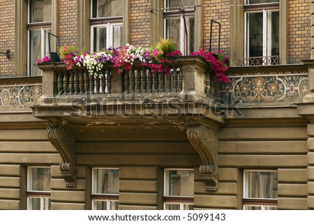 The balcony of the old house decorated by flowers