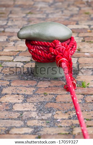 Berthing curbstone with the reeled up red rope
