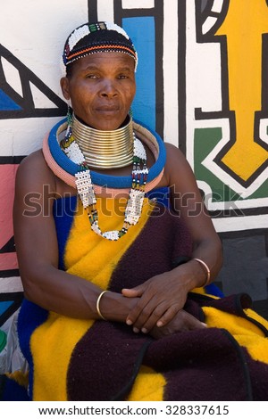 HOEDSPRUIT, SOUTH AFRICA - FEBRUARY 27: a ndebele woman while sitting in a typical dress of the village february 27, 2007 in Hoedspruit, South Africa