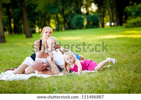 Family having fun in a park during beautiful summer evening