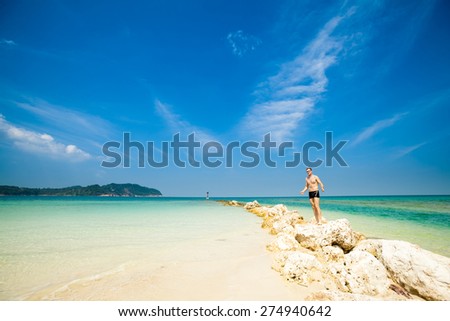 Young man on tropical island Koh Phangan in Thailand. Tourist on Chalokum beach.