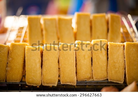 Fresh fried pieces of tofu on market. Traditional thai cuisine.