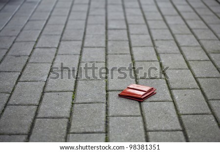 Lost leather wallet with money lost at sidewalk