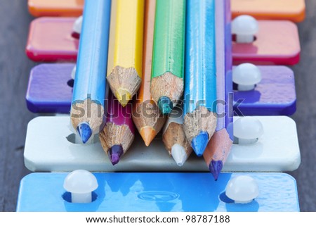 Group of colored pencils and school bells. Back to school concept.
