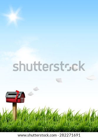 flying paper letter and post box on green grass lawn field over blue sky white clouds sunlight beaming sky background