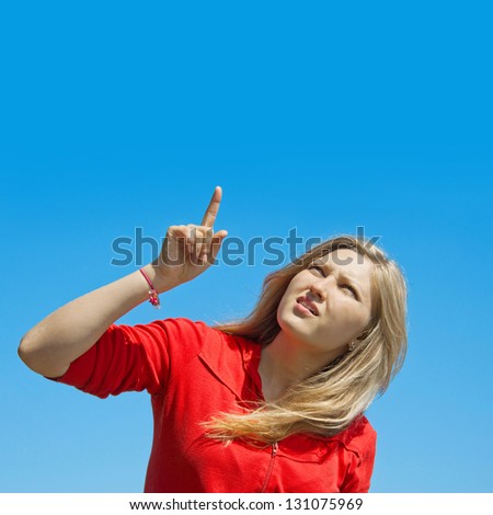 confused girl points a finger upwards
