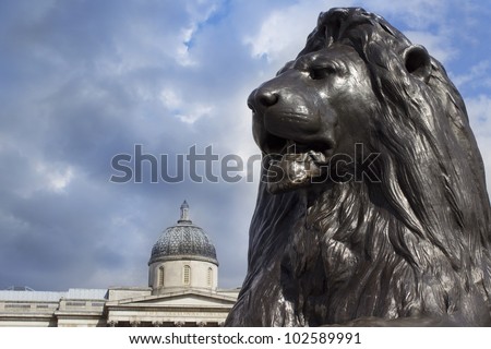 Lion in Trafalgar Square with National Portrait Gallery, London, England