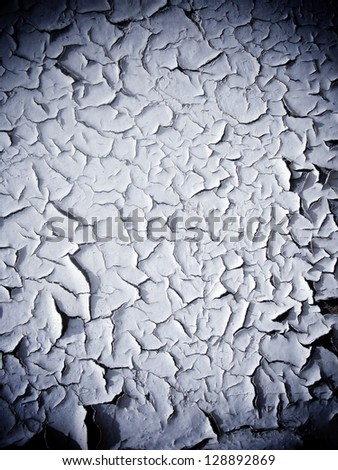 Cracked white paint with dark shadow