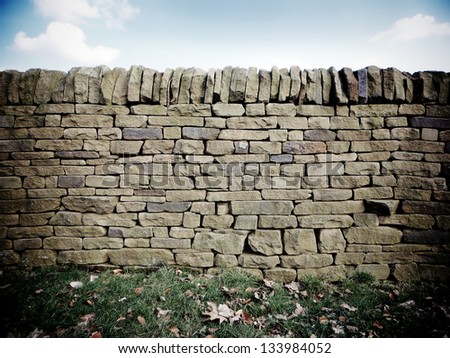 Dry stone wall with fallen leaves