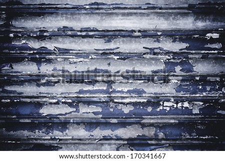 Peeling blue paint on metal