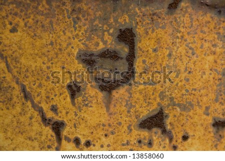 Scratched metal background with dark brown rust showing though
