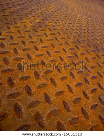 Dark orange shadow cast on rusty metalwork abstract background with diagonal grid shape pattern