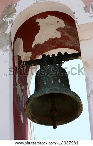 Church bell hanging from arch of bell tower, Fiskardo Kefallonia Greece