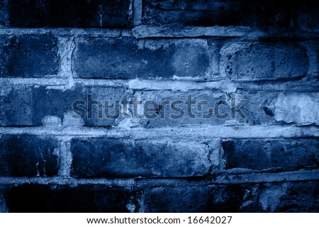 Old distressed and worn blue brick wall background with dark shadow pattern