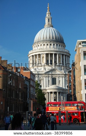 Red London bus passing in front of St Pauls Cathedral, London, England