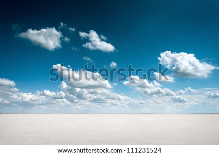 desert landscape with deep blue sky and clouds