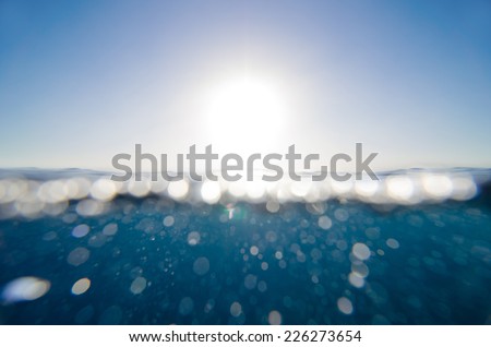 split underwater and sky background with sun and sunbeam