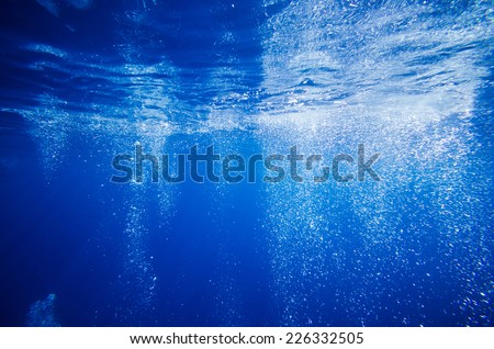 Underwater bubble in deep blue tropical sea