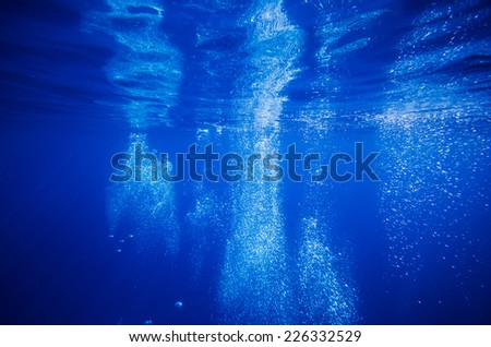 Underwater bubble in deep blue tropical sea
