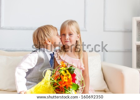 A boy is kissing a girl. Studio shot