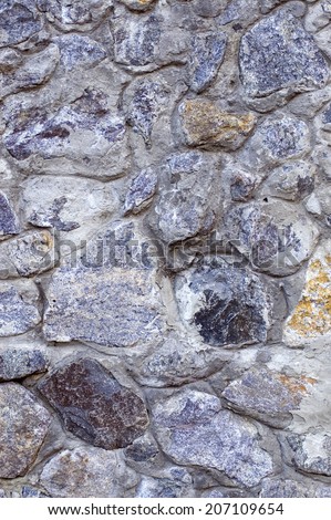 Fragment of stone wall built from granite blocks