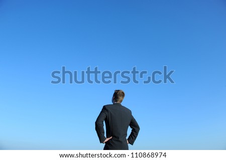 Businessman and blue sky. Above space for text or graphics. / On the top of the World