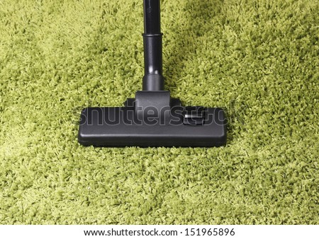 Vacuum cleaner on Green carpet