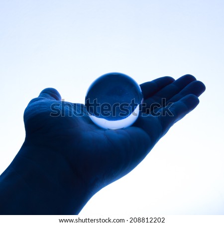 Glass Ball on Hand in Tungsten Light
