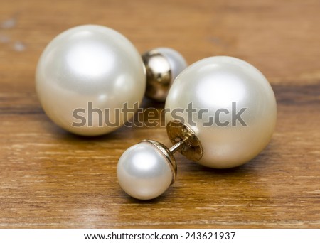 Old Pearl Earrings on Wooden floor