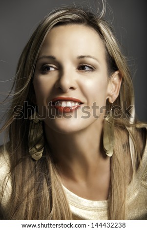 Portrait of beautiful smiling mature woman with long blonde hair and orange red lips