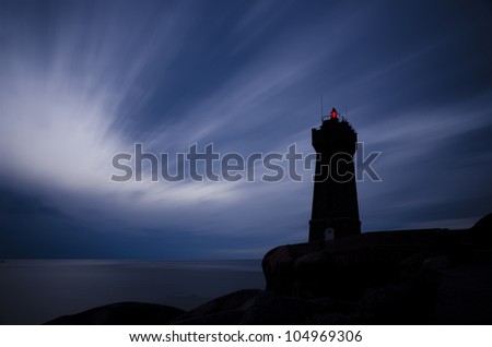 Lighthouse. Lighthouse at night with red light and blue sky; long exposure picture