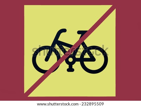 Photo of a bicycles using restriction sign with yellow background | Bicycles are not allowed | No bicycles | Bicycles using is prohibited