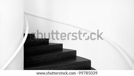 Spiral staircases between white walls and black floor; Interior stairs in black and white Stairs: up and down, black and white