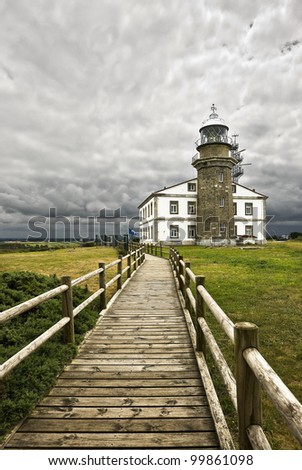 Beautiful and picturesque lighthouse at Spain and the walkway leading to it/The way to the lighthouse