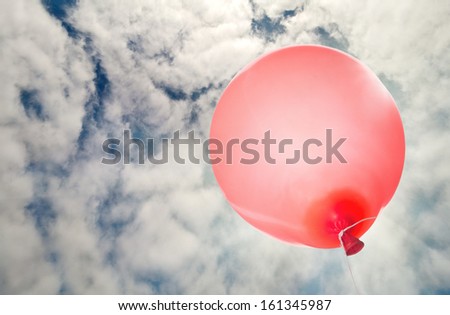 single red balloon flying to sky with clouds