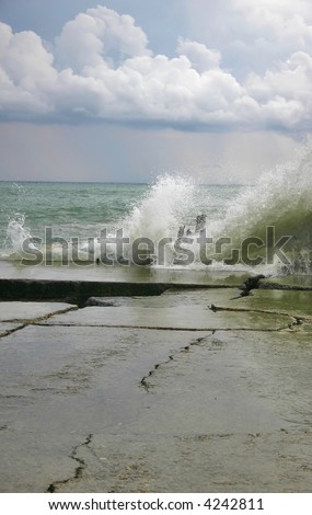 Storm on the sea with high waves under the sky with thunderclouds