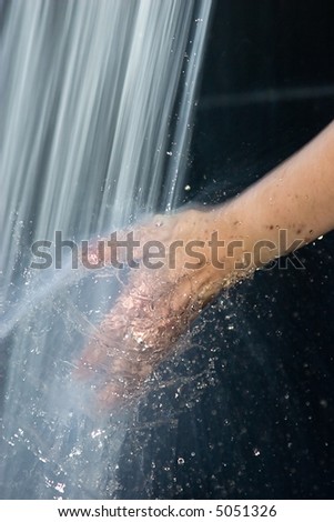 woman hand in the water spray