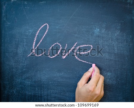 Writing love with chalk on black board