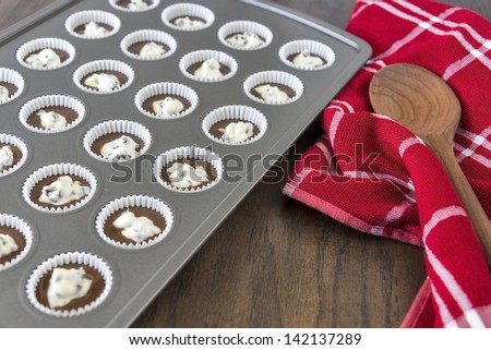 A tray full of unbaked Black Bottom Mini-Cupcakes ready to go into the oven.