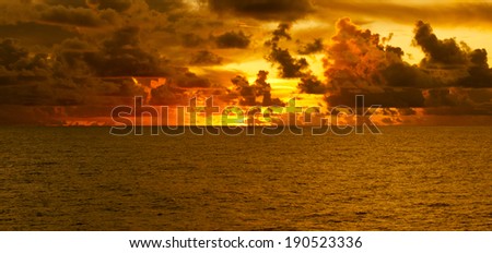 Golden sunset with clouds over the Atlantic Ocean at the Equator.