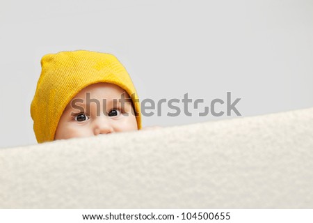 Cute Baby looking behind a sofa