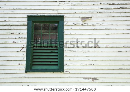 Architectural Details show peeling paint and an old window