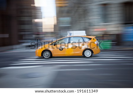 NEW YORK - APRIL 6: A panning technique was used to photograph New York City Taxis and show motion as they drive through the city streets; Photo taken on April 6, 2014