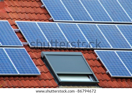 Solar panels on a red roofing tile