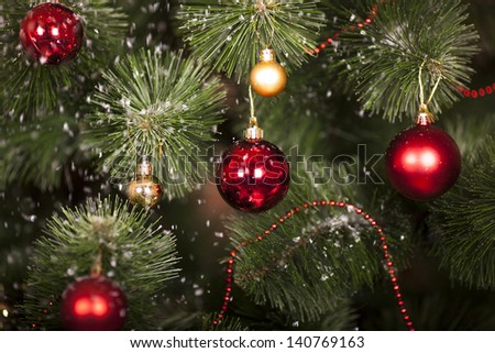 Christmas toys on a Christmas tree under snow