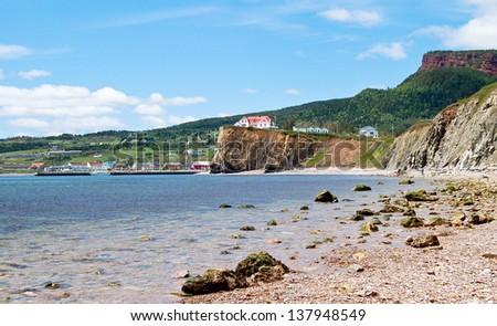 The tiny village of Perce is on the southern coast of the Gaspe Peninsula in Quebec. This photo was taken from the shore near Perce rock.