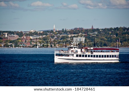 Burlington, VT, USA - September 30, 2013: Passengers gather on the decks of the ship Northern Lights on an afternoon sightseeing cruise on a sunny day day in autumn.