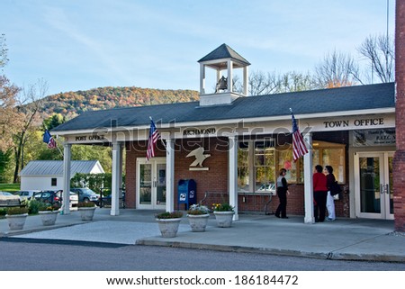 Richmond, VT, USA - October 10, 2013: Local residents pause to chat with each other outside the Richmond Town Offices on a sunny autumn afternoon.