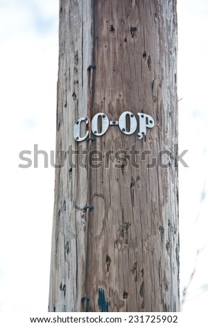 The letters on this telephone pole show that it is owned by an electrical cooperative. Electrical co-ops provide power throughout many of the rural areas of the United States.