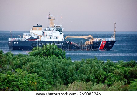 Rye, NH, USA - August 7, 2014: USCG ship Marcus Hanna waits out a summer storm at the entrance to Gosport Harbor off Star Island.